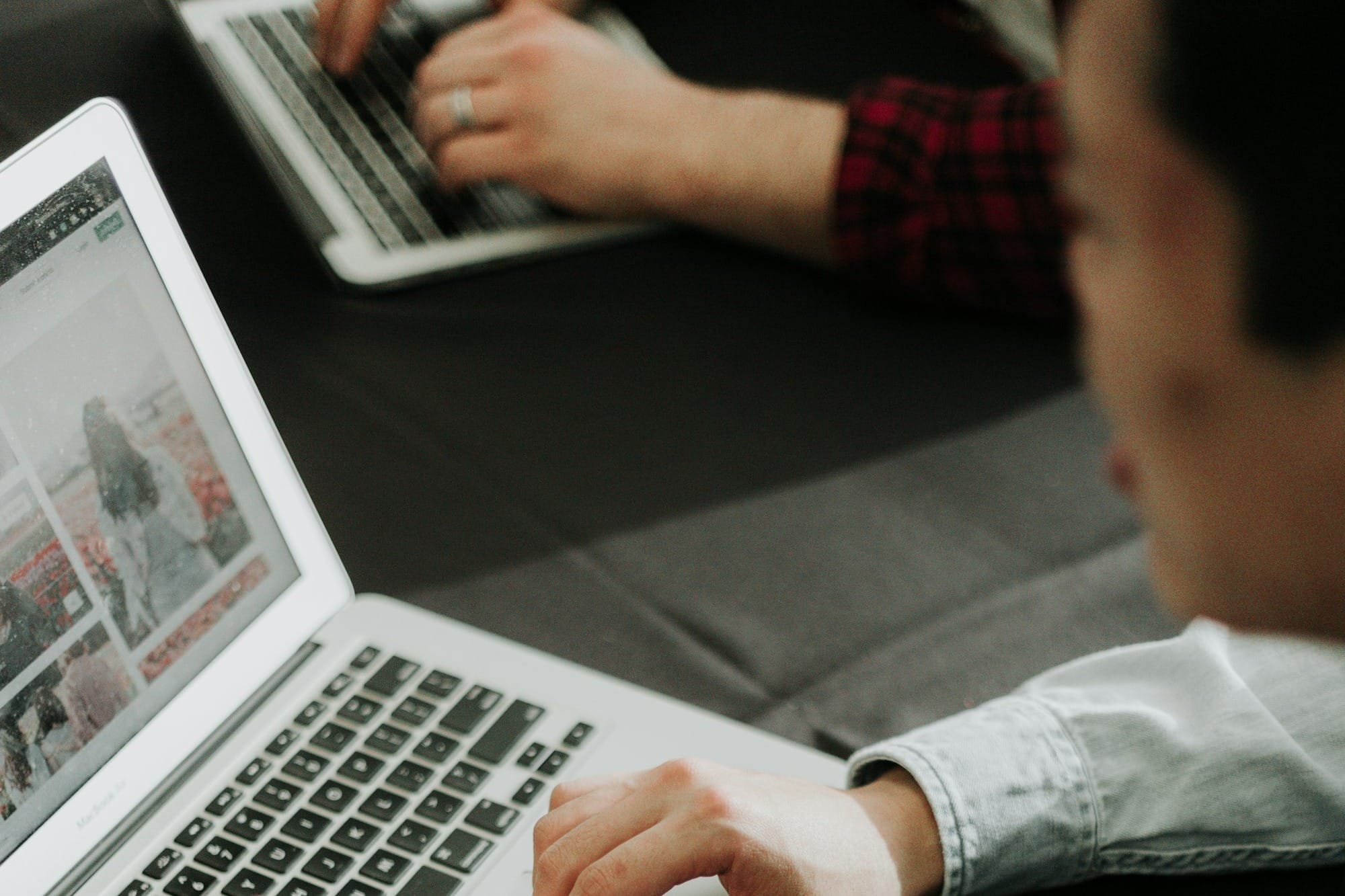 a man sitting at a table using a laptop computer