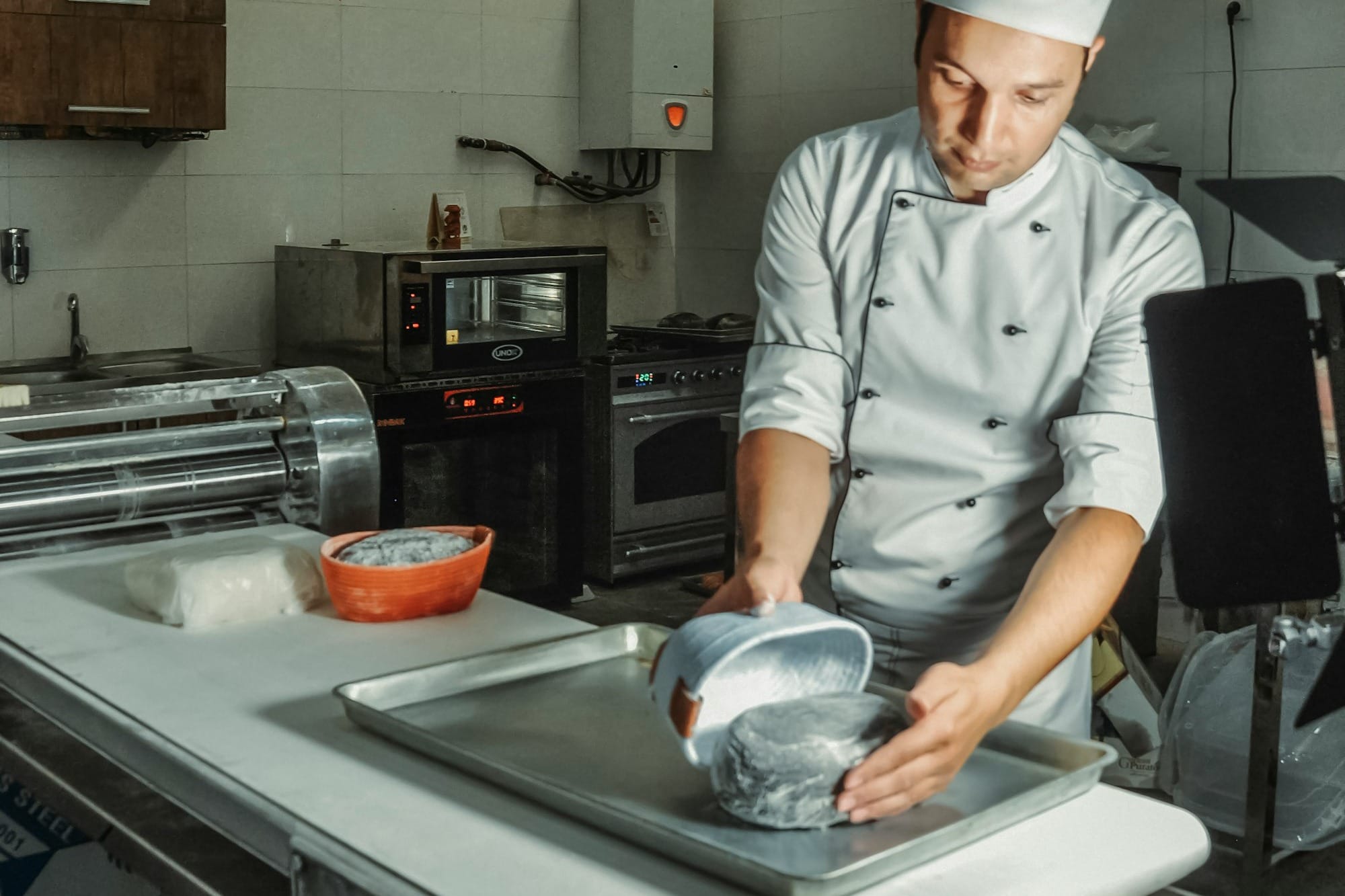 a chef making bread in a kitchen